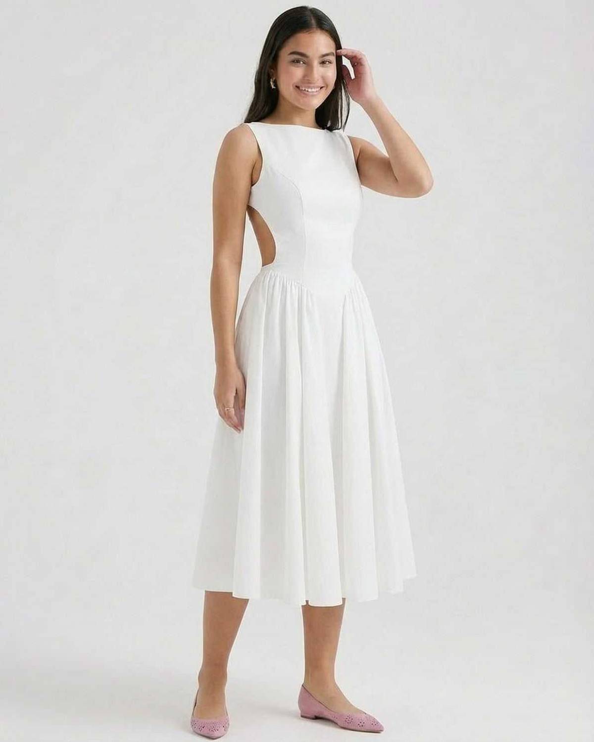 Side view of white midi dress with open waist cutout and flowing skirt